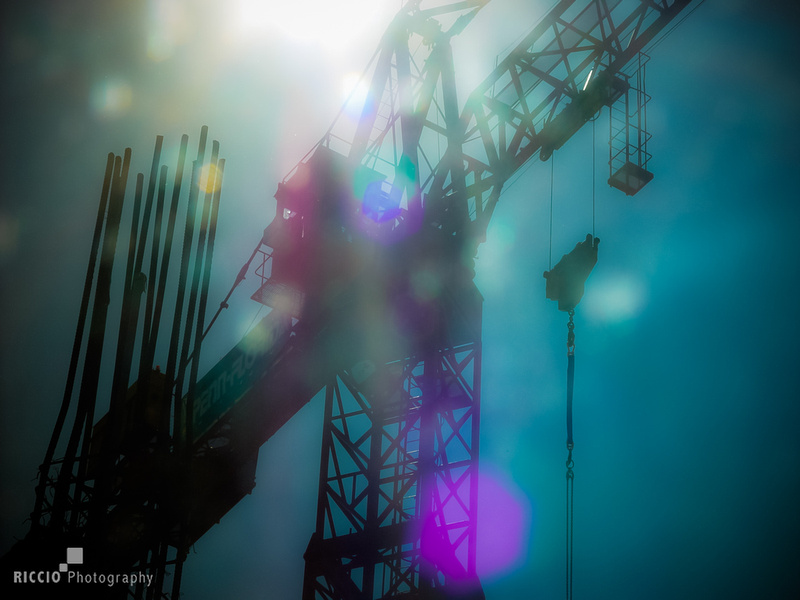 Constructions cranes photographed against the sun