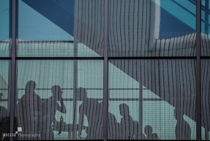 Silhouette of business people behind glass